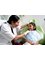 Dr. Smilez Dental Clinic Anna Nagar - Doctor consulting a child patient 