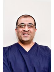 Dr Tuss Tambra - Dentist at Birmingham Periodontal & Implant Centre
